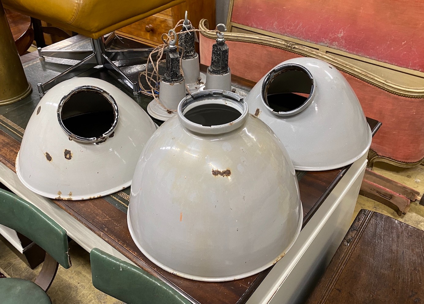 A set of three vintage industrial enamel shades